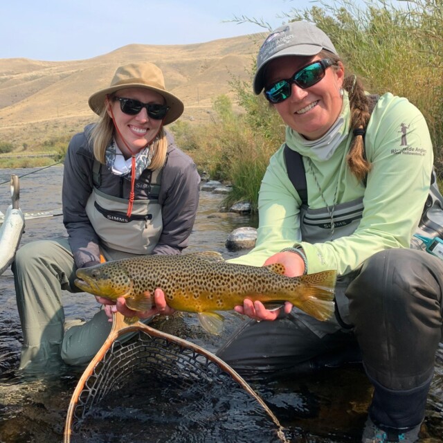 Alice and friend holding fish